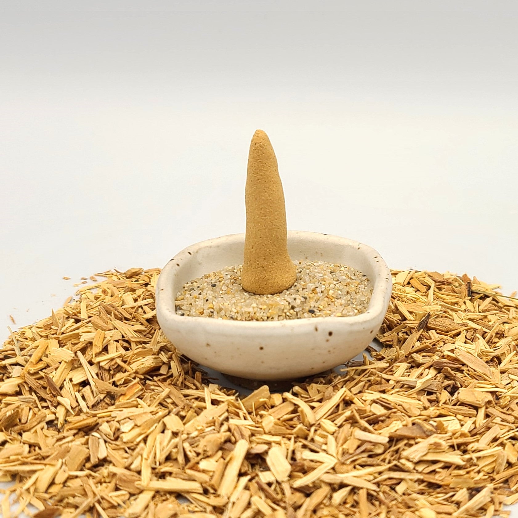 Australian Sandalwood organic incense cone in an incense holder.
