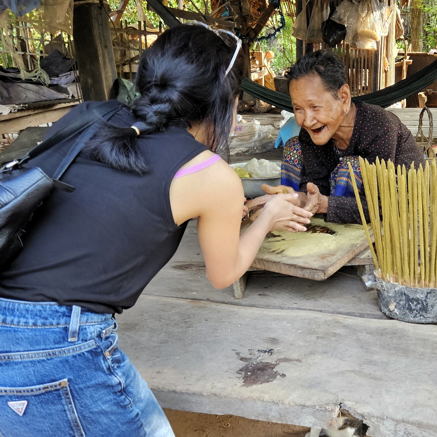 A photo of beautiful Kheoun at her home in a traditional wooden Cambodian home.