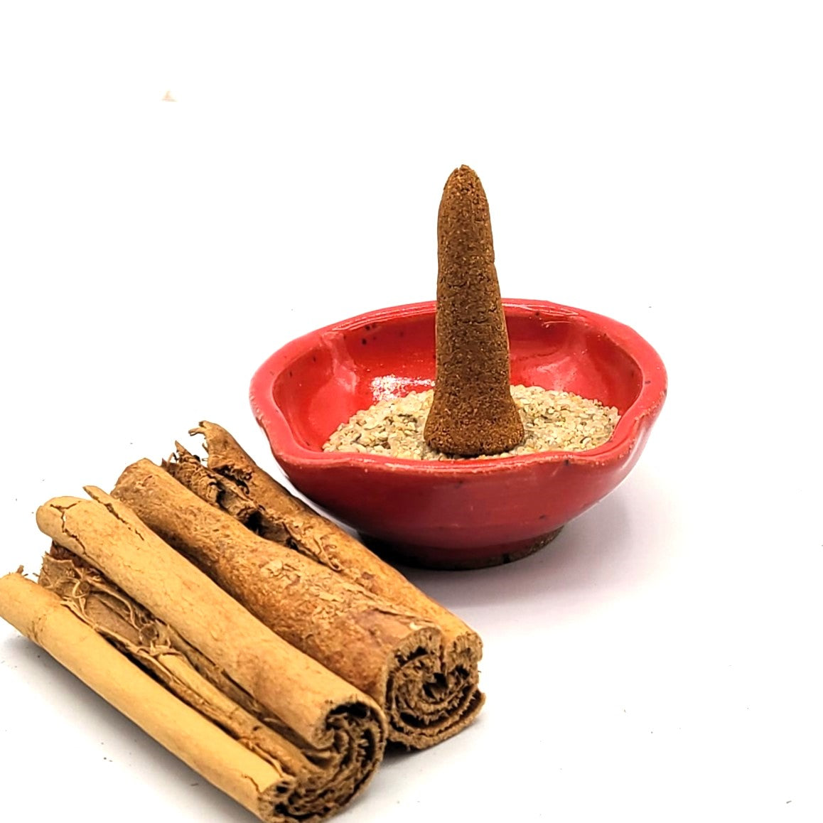 Cinnamon organic incense cone in an incense holder.