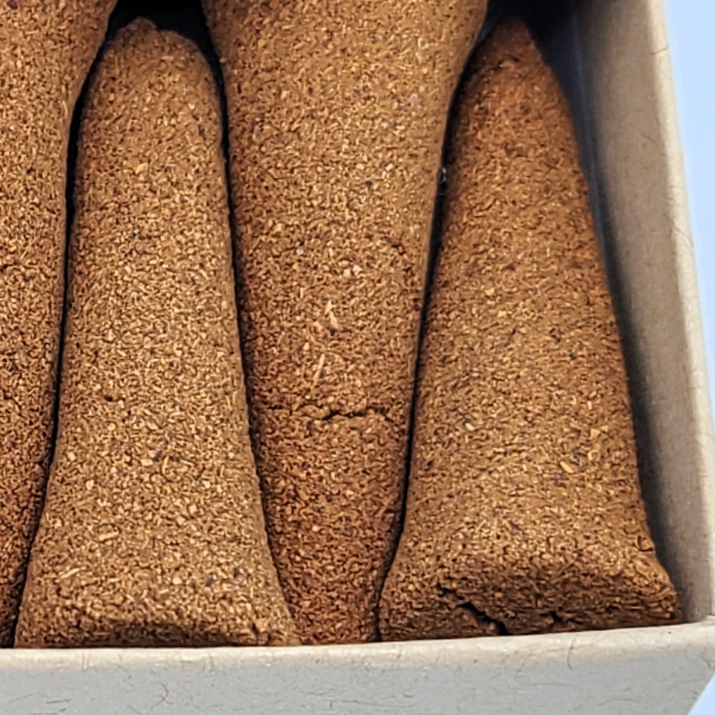 Close up detailed photo of Cinnamon organic incense cones.