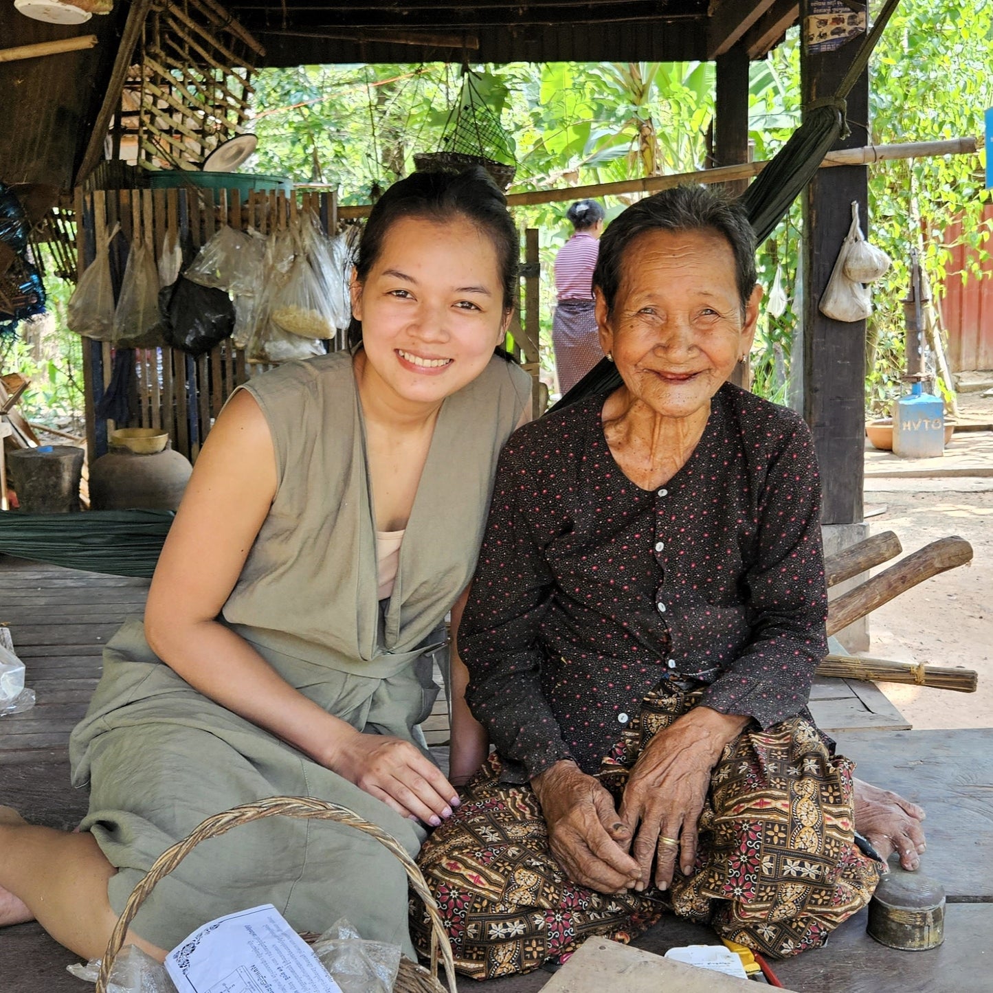 A photo of beautiful Kheoun at her home in a traditional wooden Cambodian home.
