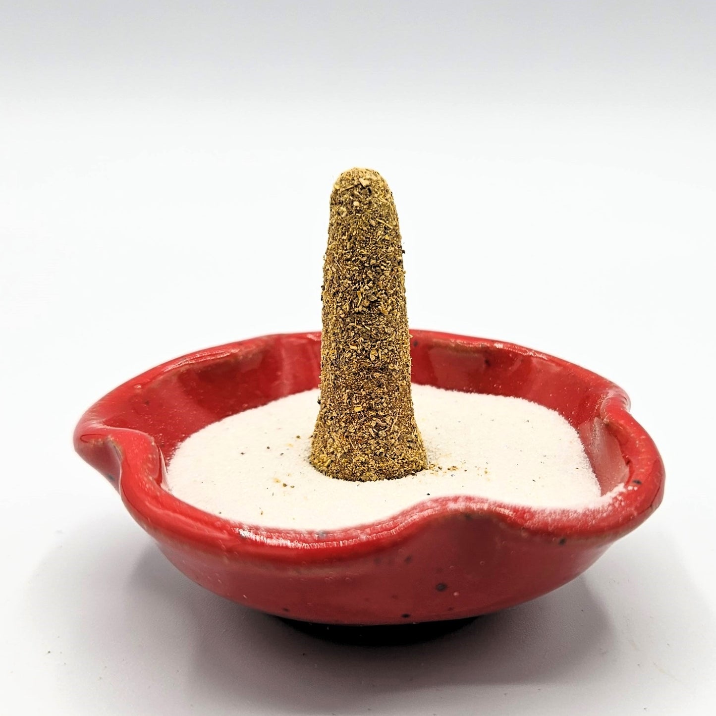 Kheoun's Blend organic incense cone in an incense holder.