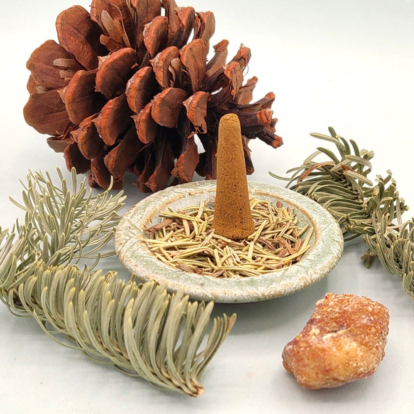 North Winter Woods organic incense cone in an incense holder.