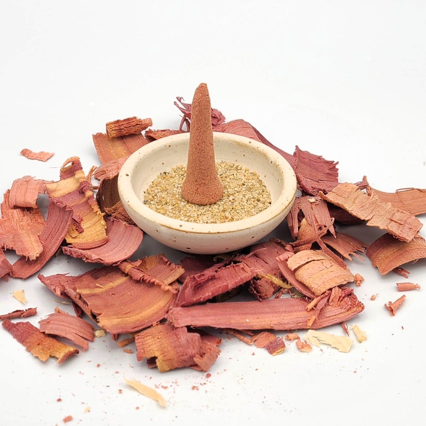 Red Cedar organic incense cone in an incense holder.