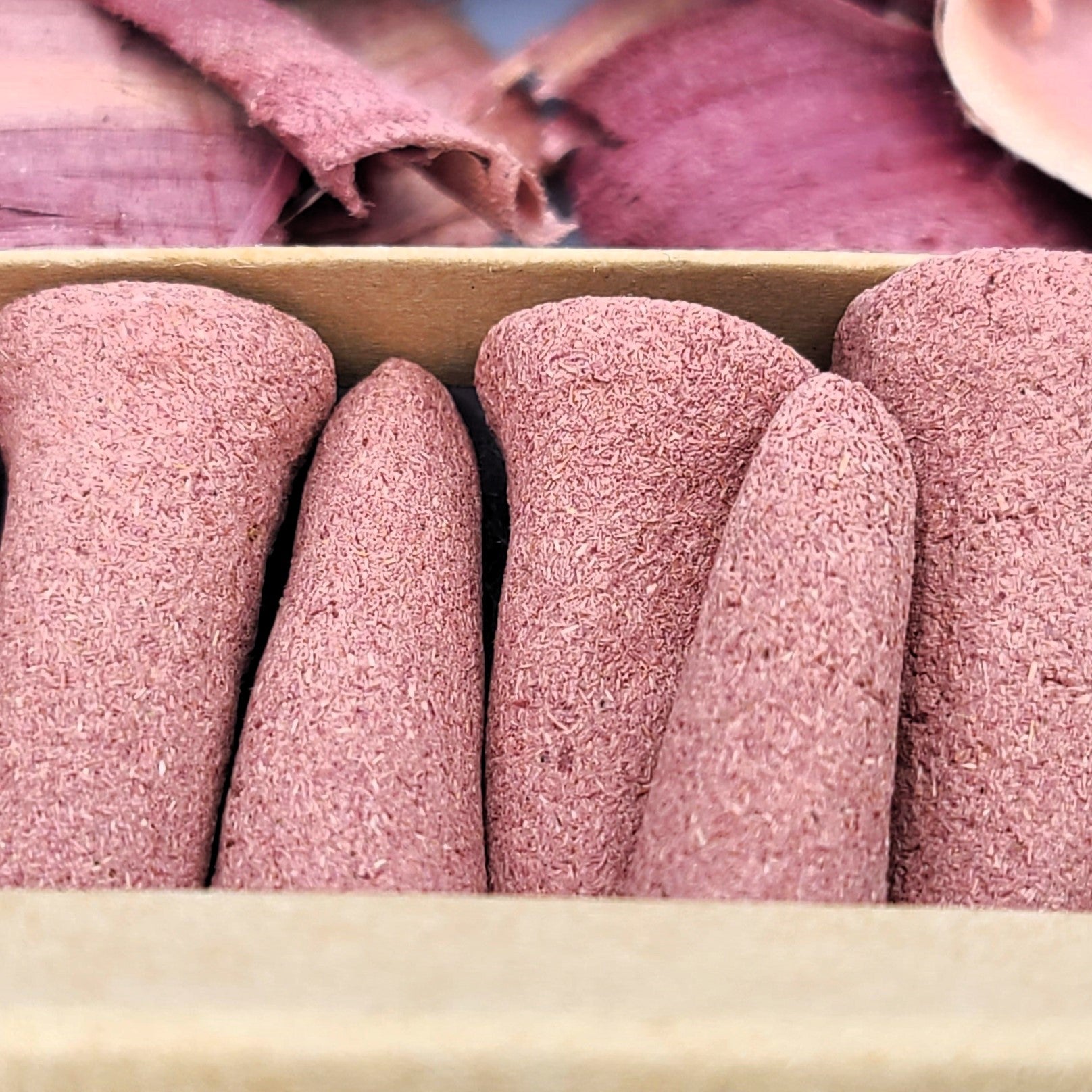 Close up detailed photo of Red Cedar organic incense cones.