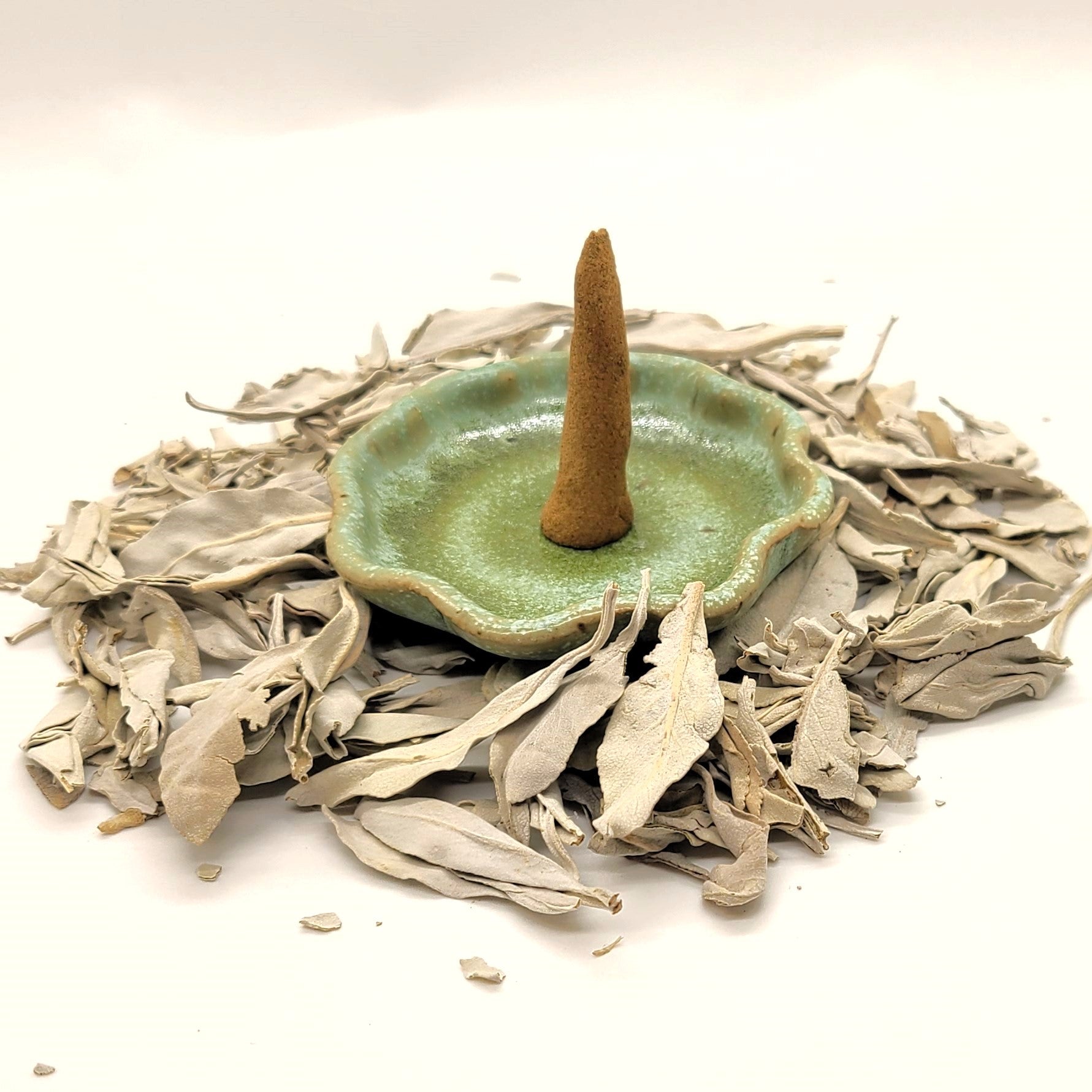 White Sage organic incense cone in an incense holder.