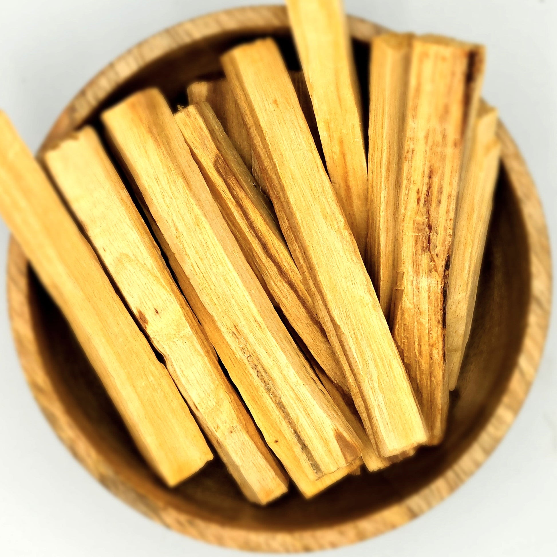 A bowl showcasing organic Palo Santo ingredients.